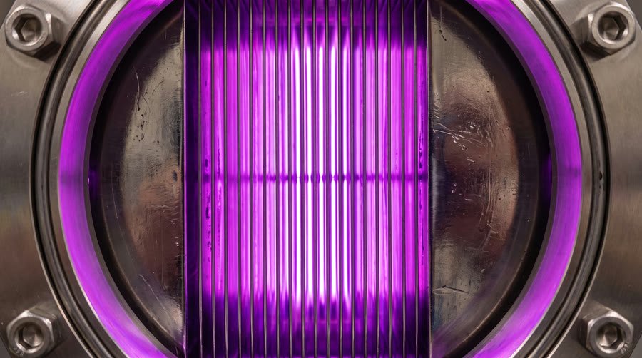 Close view of a plasma discharge inside a process duct behind a bolted flange