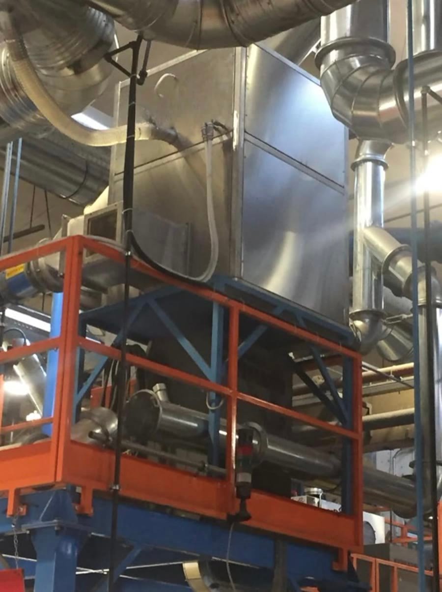 A stainless plenum and its ducting on an access platform above the furnace